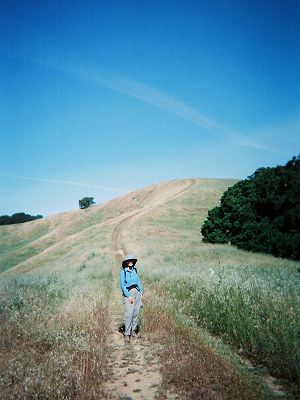 Joy on a trail that continues to a hilltop and disappears