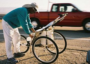 Dinesh, at roadside, arranging items on the baby jogger